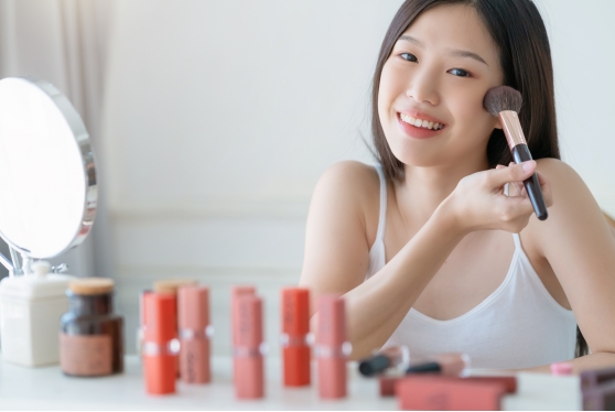 beautiful-asian-woman-white-tshirt-smile-with-happiness-hand-hold-blush-makeup-cosmetic-items-bedroom-with-healthy-face-skincare-concept