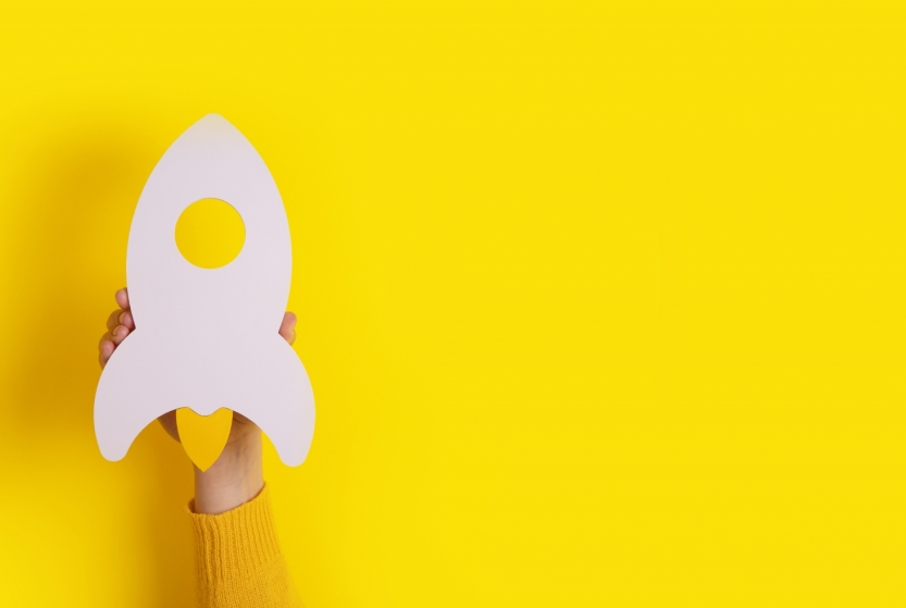 startup-rocket-hand-yellow-background-panoramic-mockup-image-with-space-text